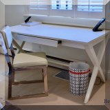 F32. Crate & Barrel white laminate desk (30”h x 58”w x 28”d ) and leatherette and chrome desk chair. 